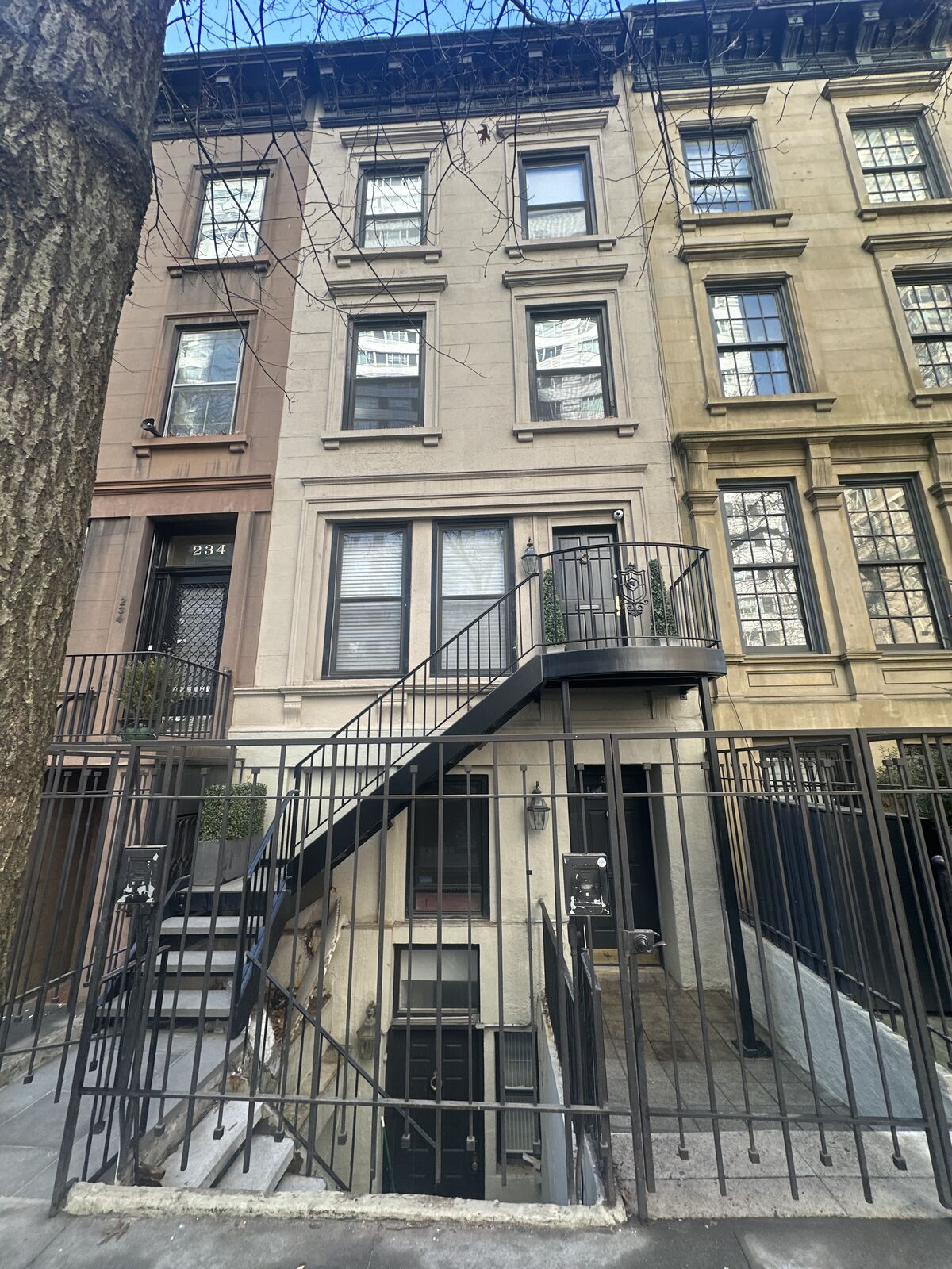 Row-house facade work with scaffold access