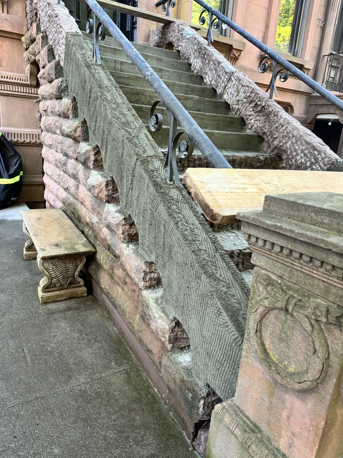 Before: failed stone at stoop cheek wall and bracket
