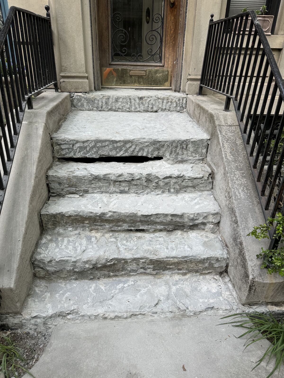 Before: delaminating brownstone face