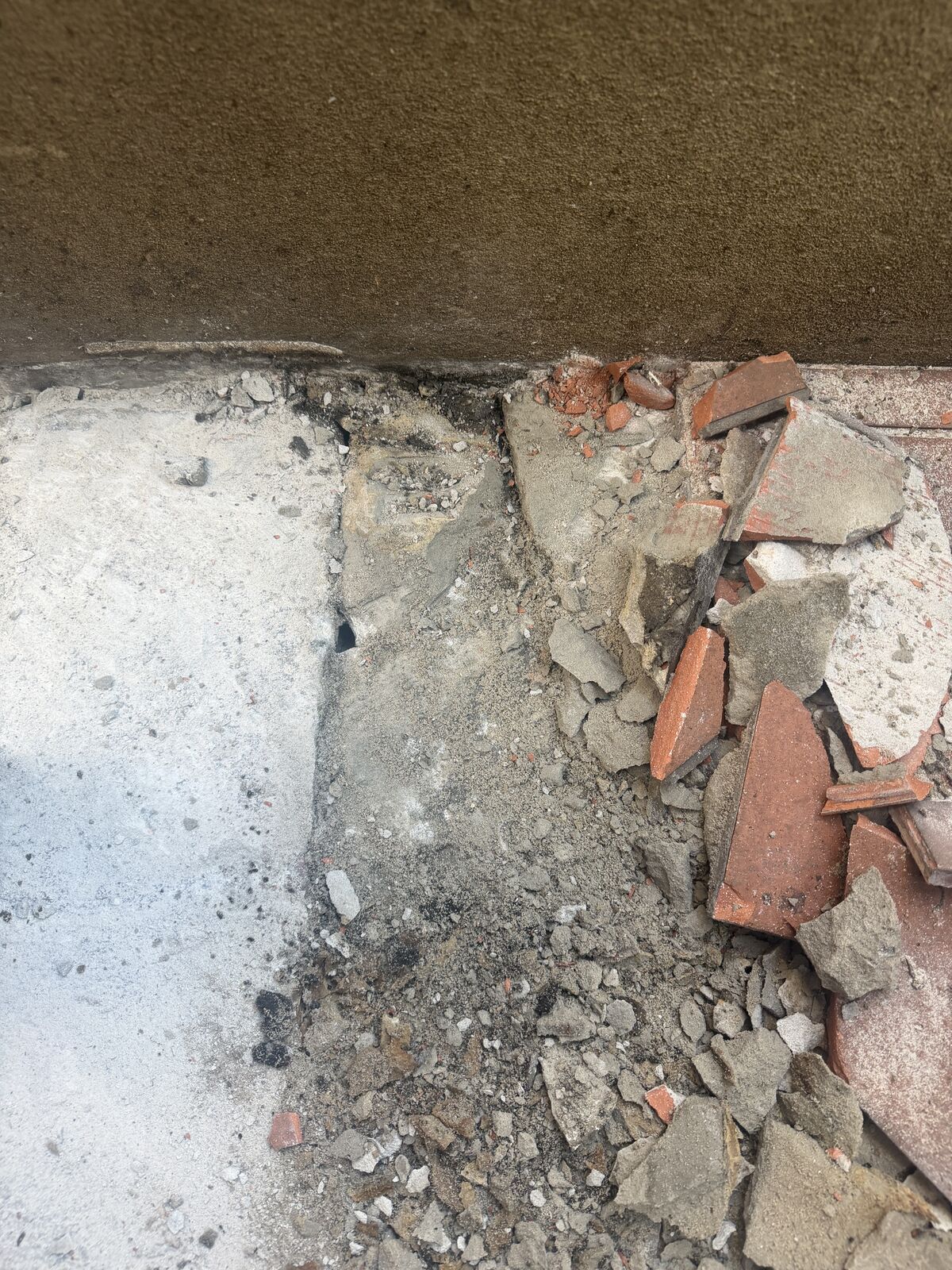 Failed tile stripped to sound material