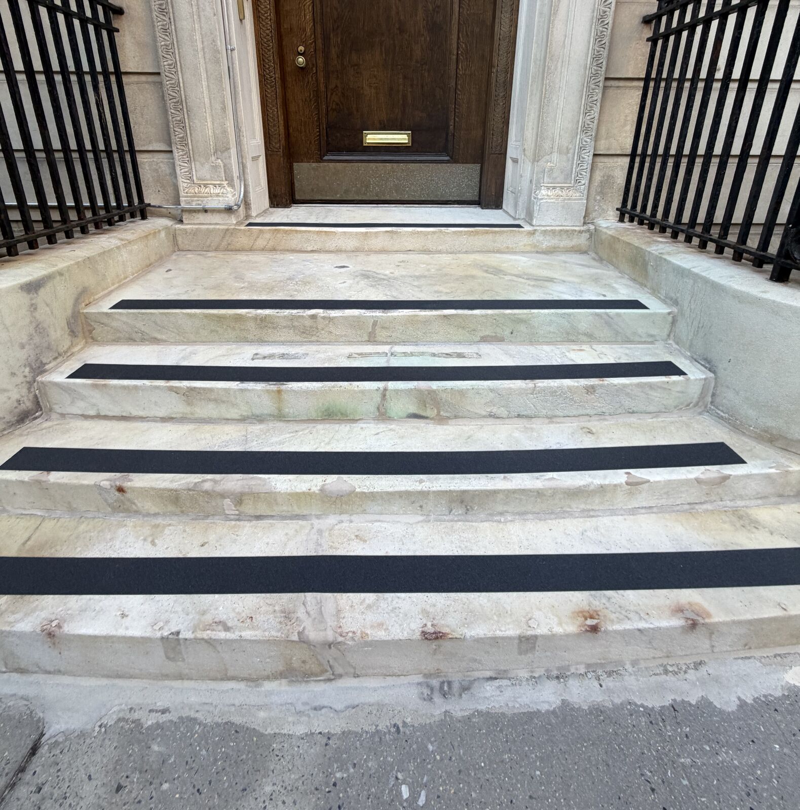 Before: soiled marble treads with anti-slip strips